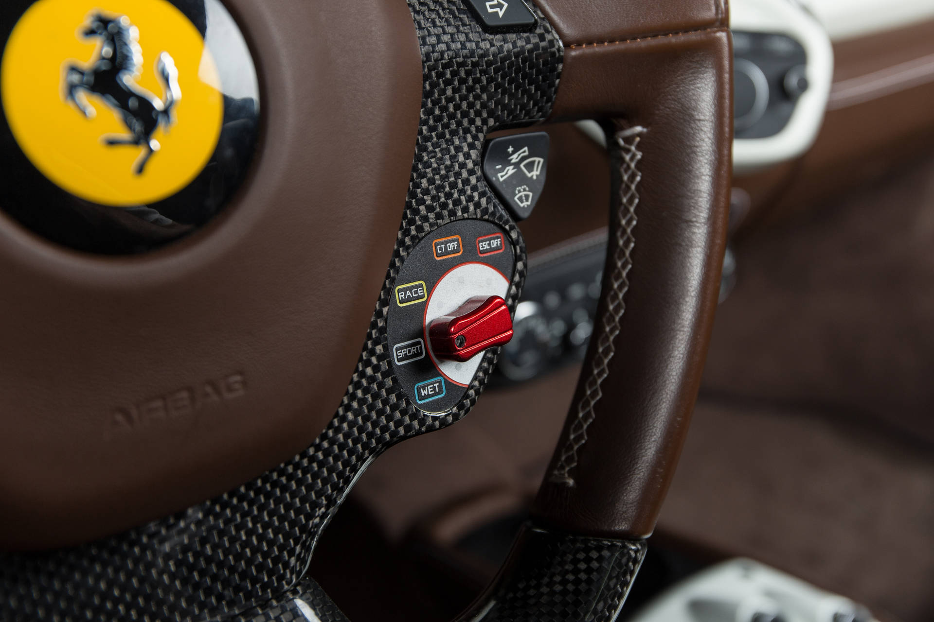 Dark brown Ferrari interior steering wheel wallpaper.