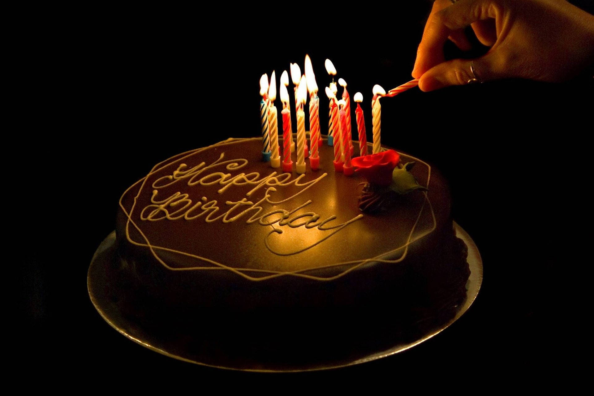 Dark Chocolate Birthday Cake Adorned with Lit Candles Wallpaper