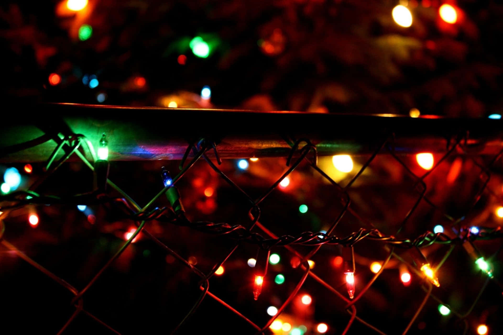 Dark Christmas Lights Fence Glow Wallpaper