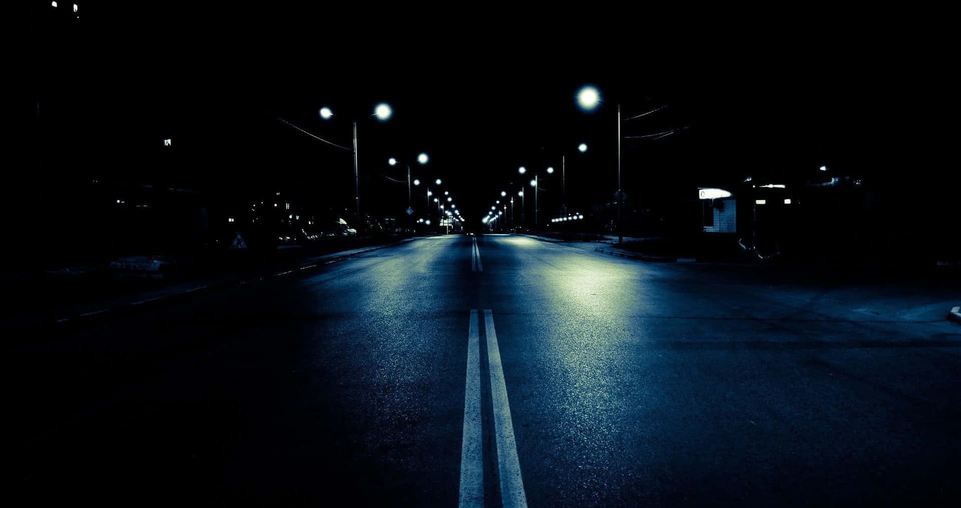 Dark Crossroad - A Mystical Path at Night Wallpaper