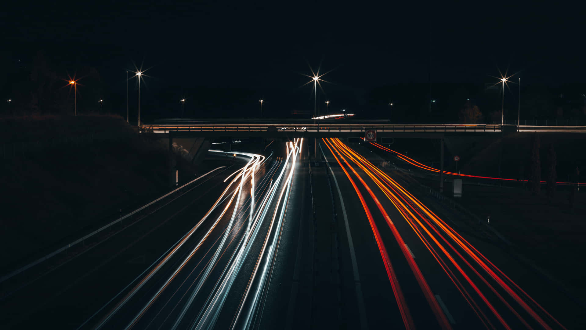 A Long Exposure Of A Highway At Night Wallpaper