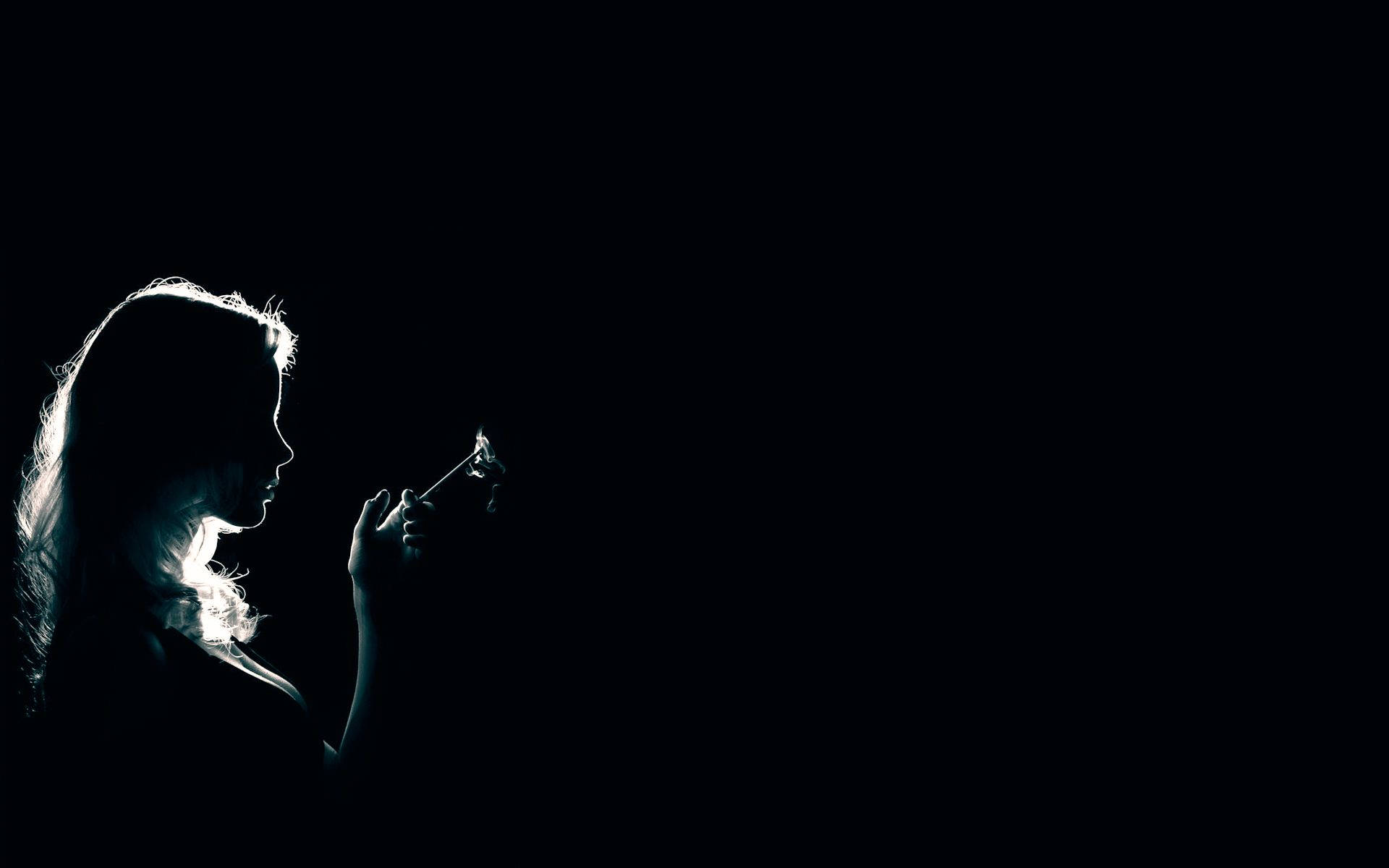 In The Shadows: Mysterious Lady Engulfed in Darkness Seeking Light Wallpaper