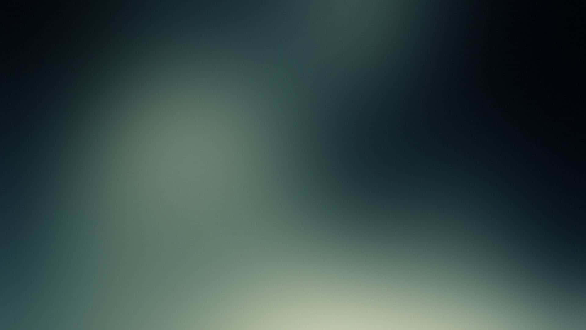 A Blurry Image Of A Green And Blue Sky Wallpaper