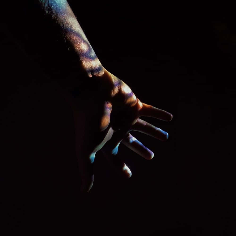 Mysterious Dark Hand reaching out from the shadows Wallpaper