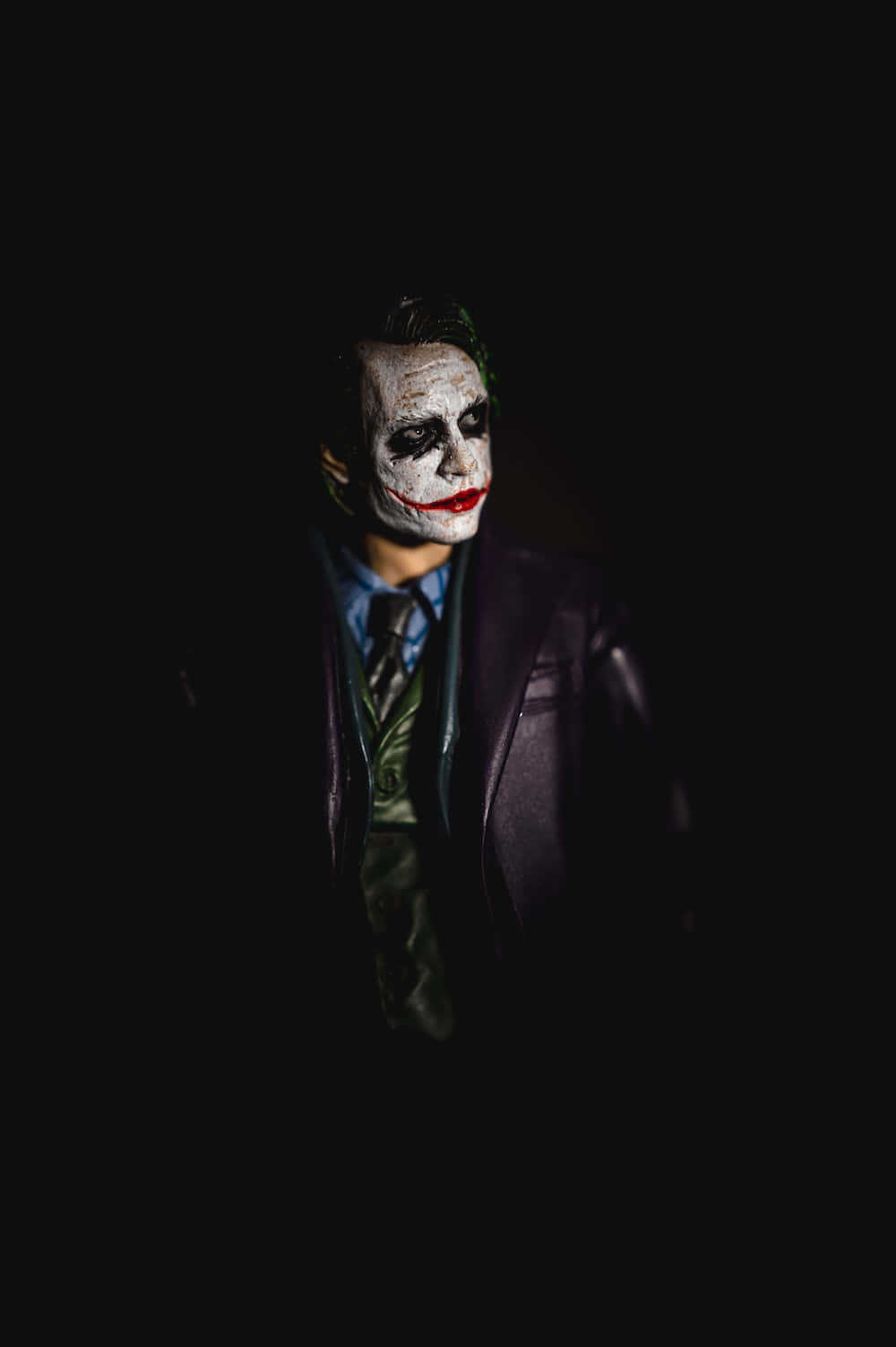 A brooding Dark Joker in a mysterious and captivating portrait Wallpaper