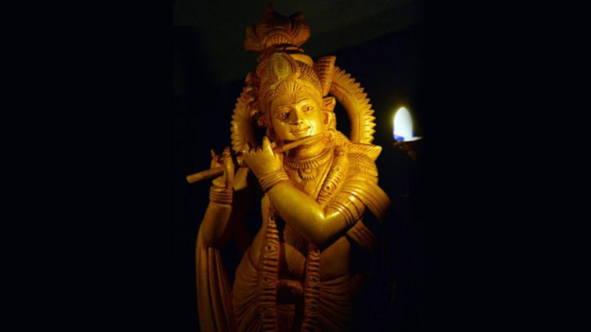 Estatuadorada De Krishna Oscuro Fondo de pantalla