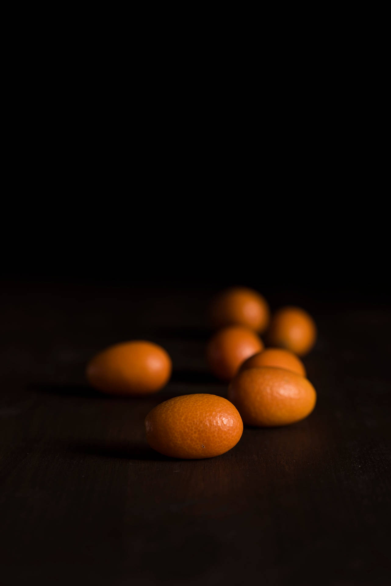 Dunklekumquat-früchte Auf Augenhöhe Fotografiert Wallpaper