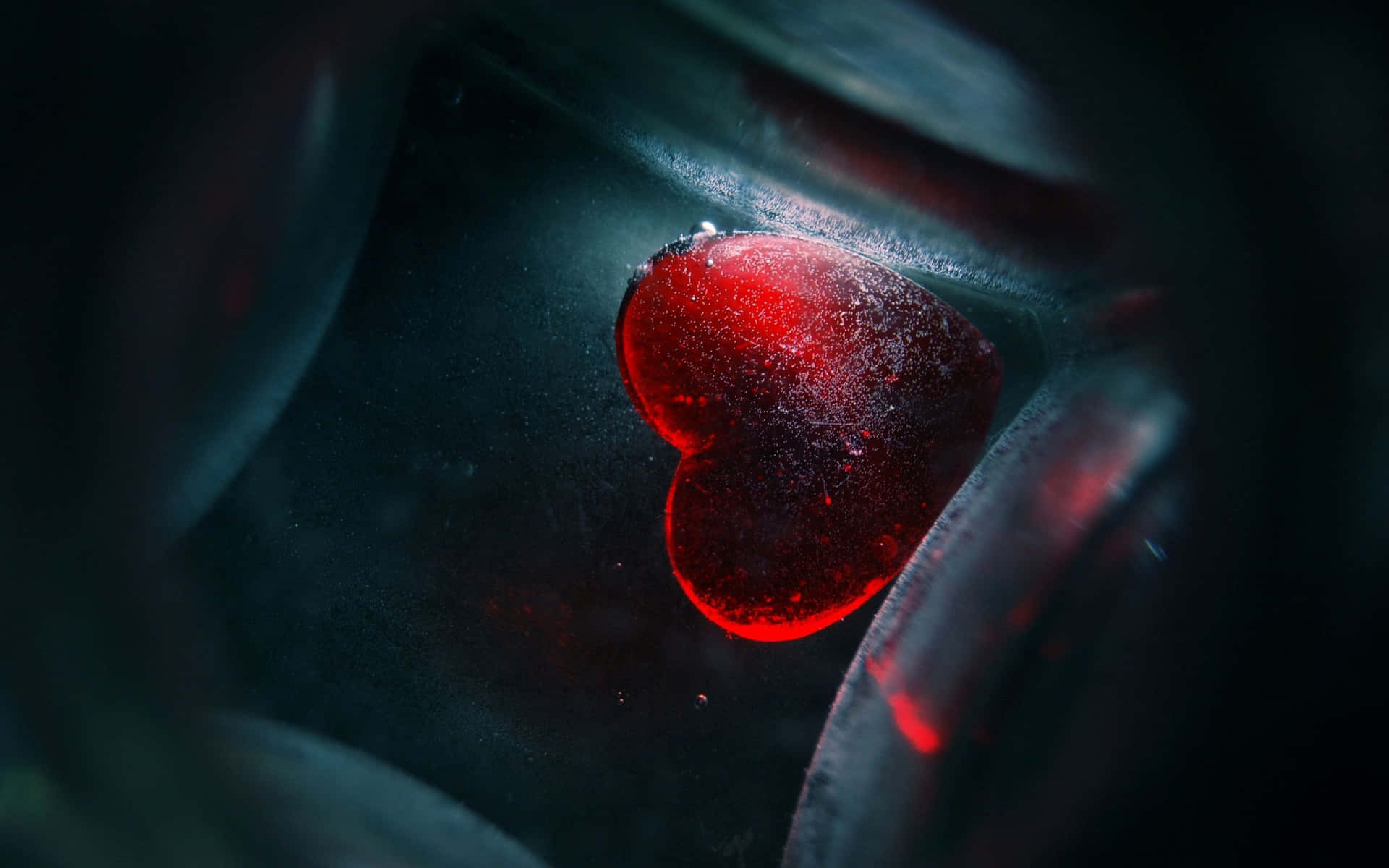 a red heart is shown in a glass bottle