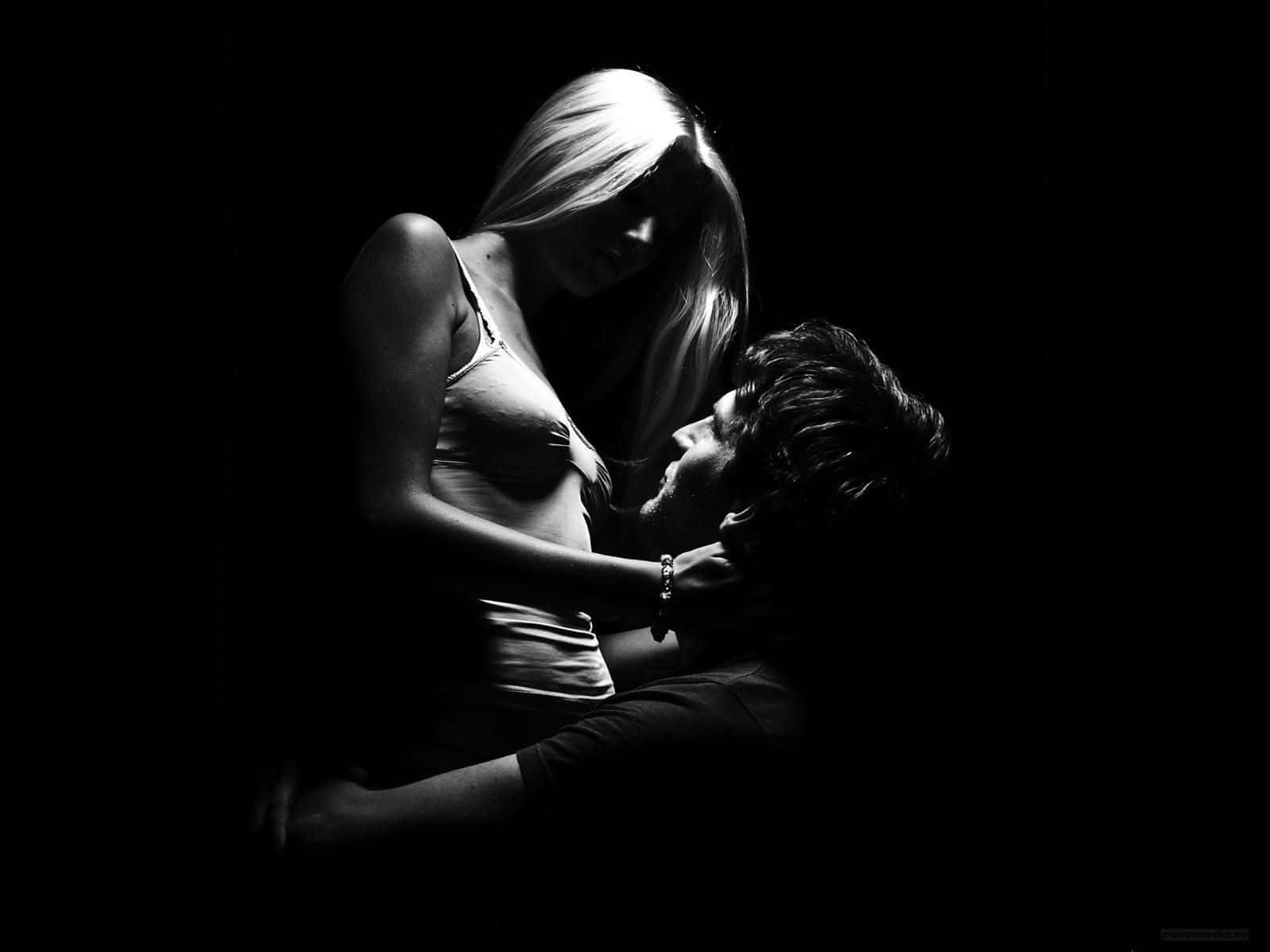 a man and woman hugging in the dark