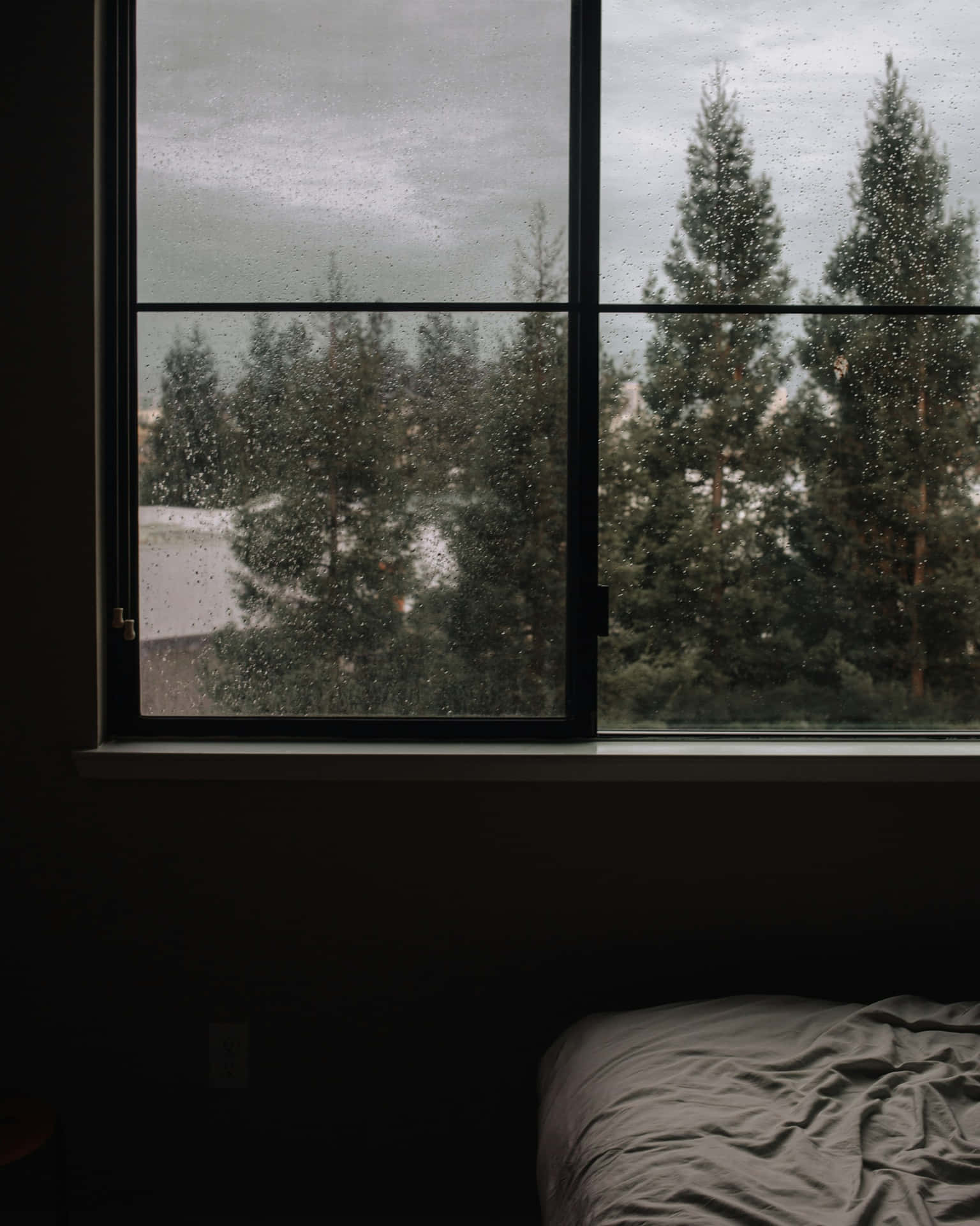 Dark Moody Bedroom With Rainy Window Wallpaper