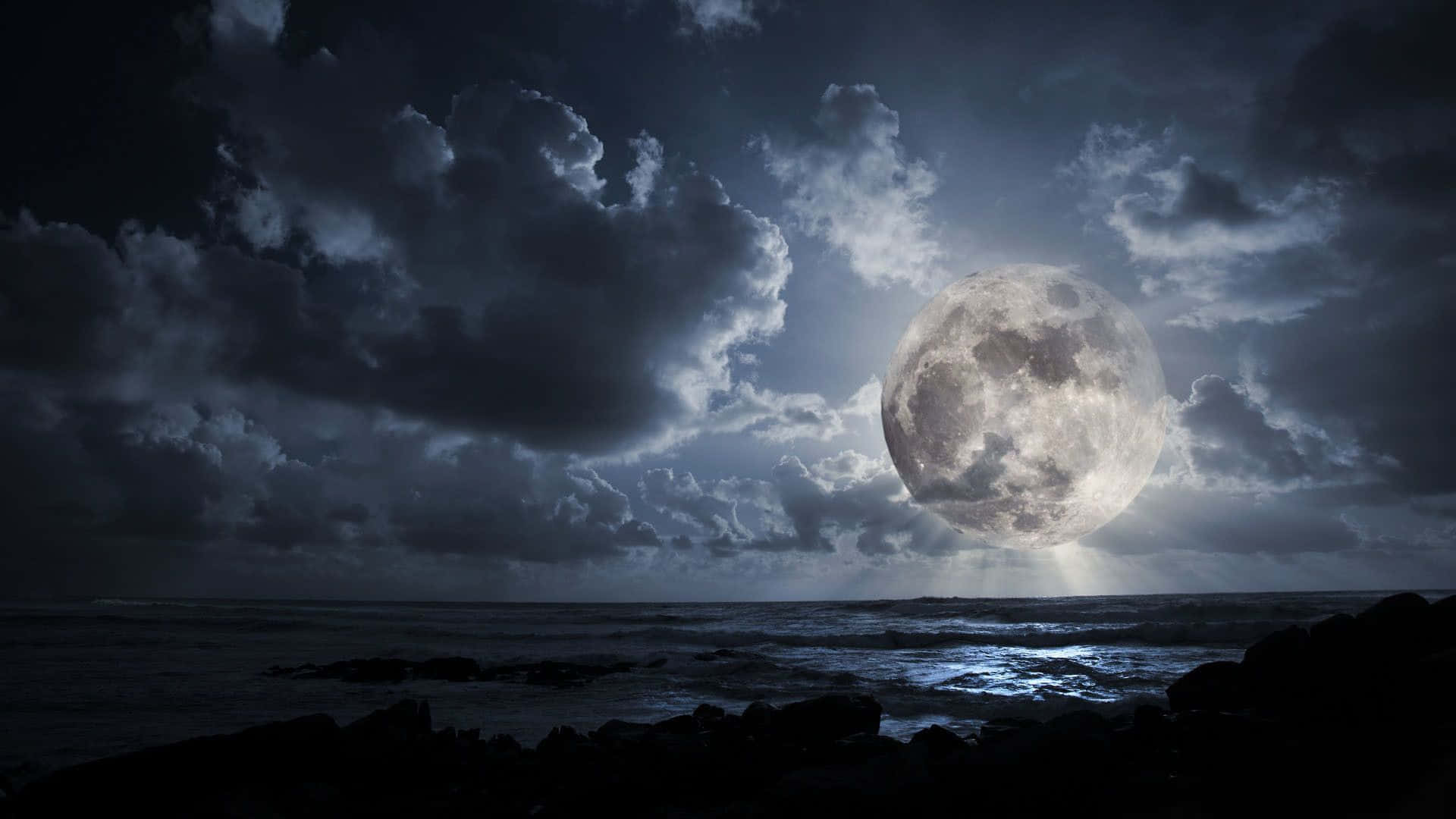 Mystical Dark Moon Illuminating the Night Sky Wallpaper