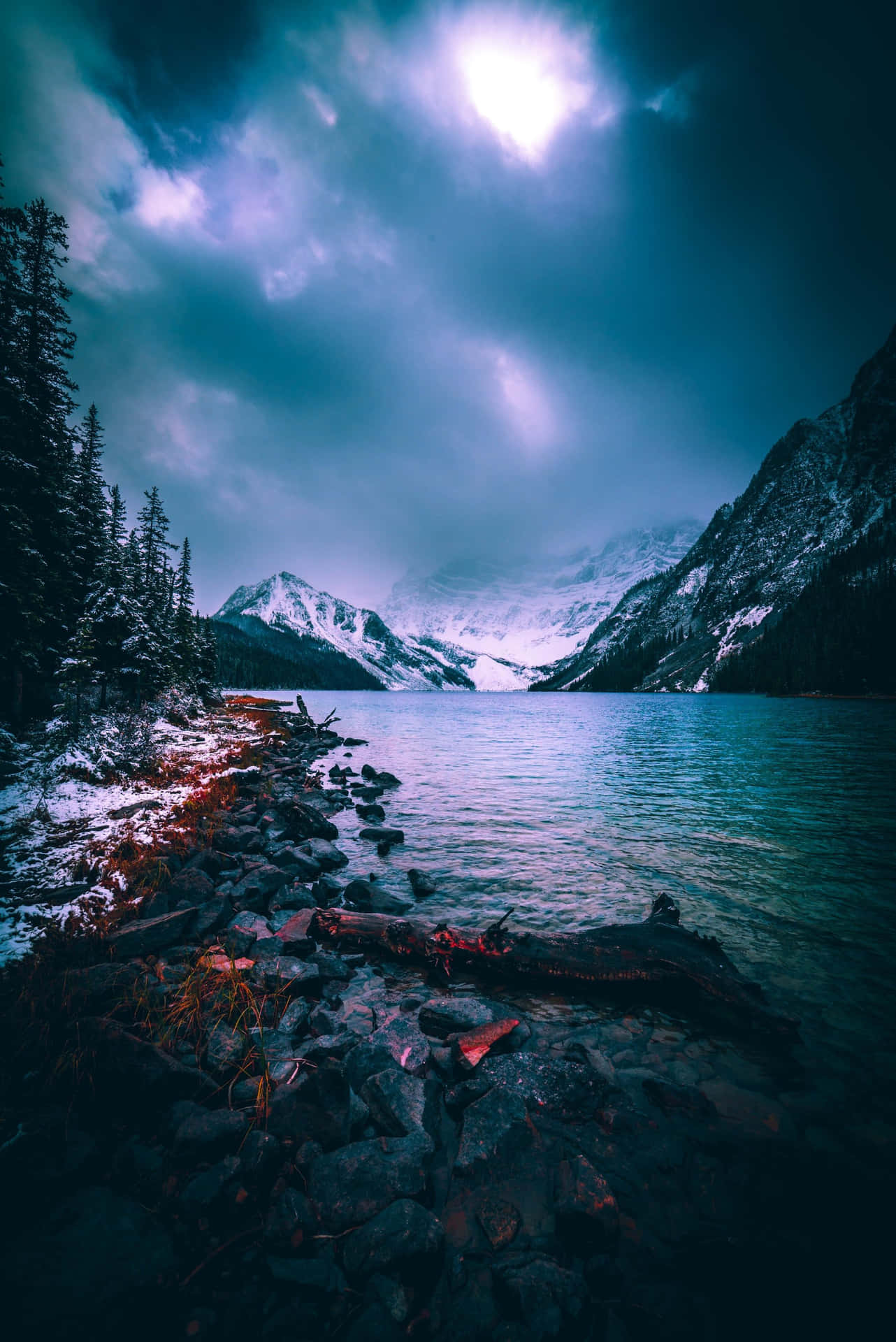 A Lake With Snow Covered Mountains And Trees Wallpaper