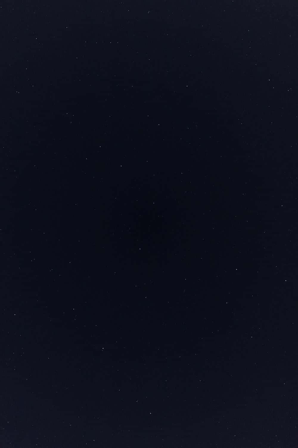 A Black Background With Stars In The Sky