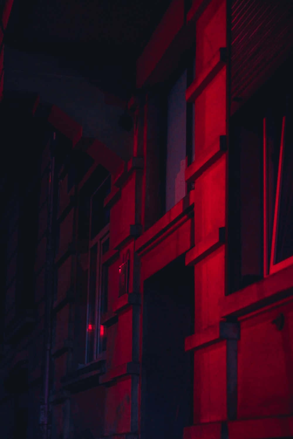 A Red Light Is Shining On A Building Wallpaper
