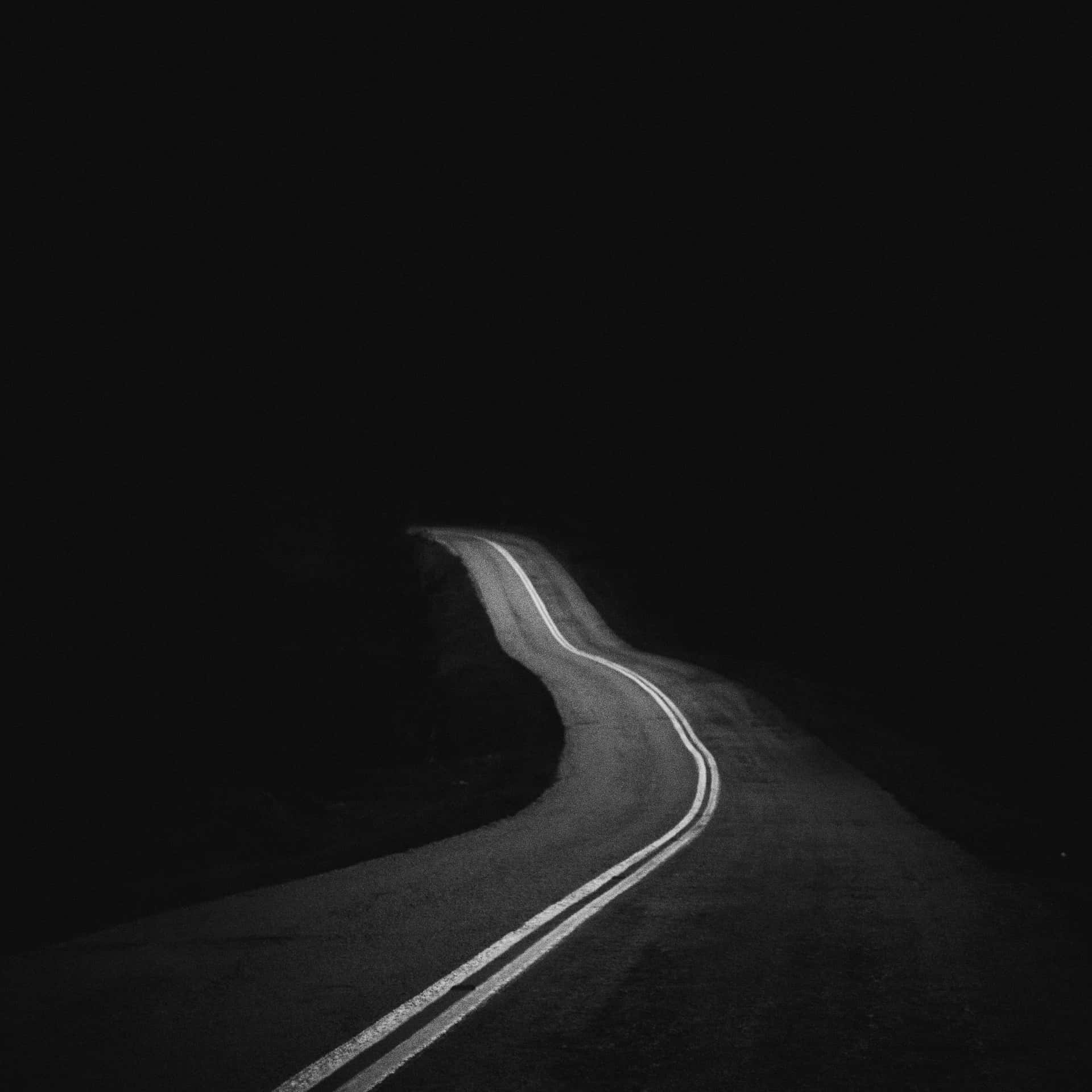Mysterious Dark Road on a Foggy Night Wallpaper
