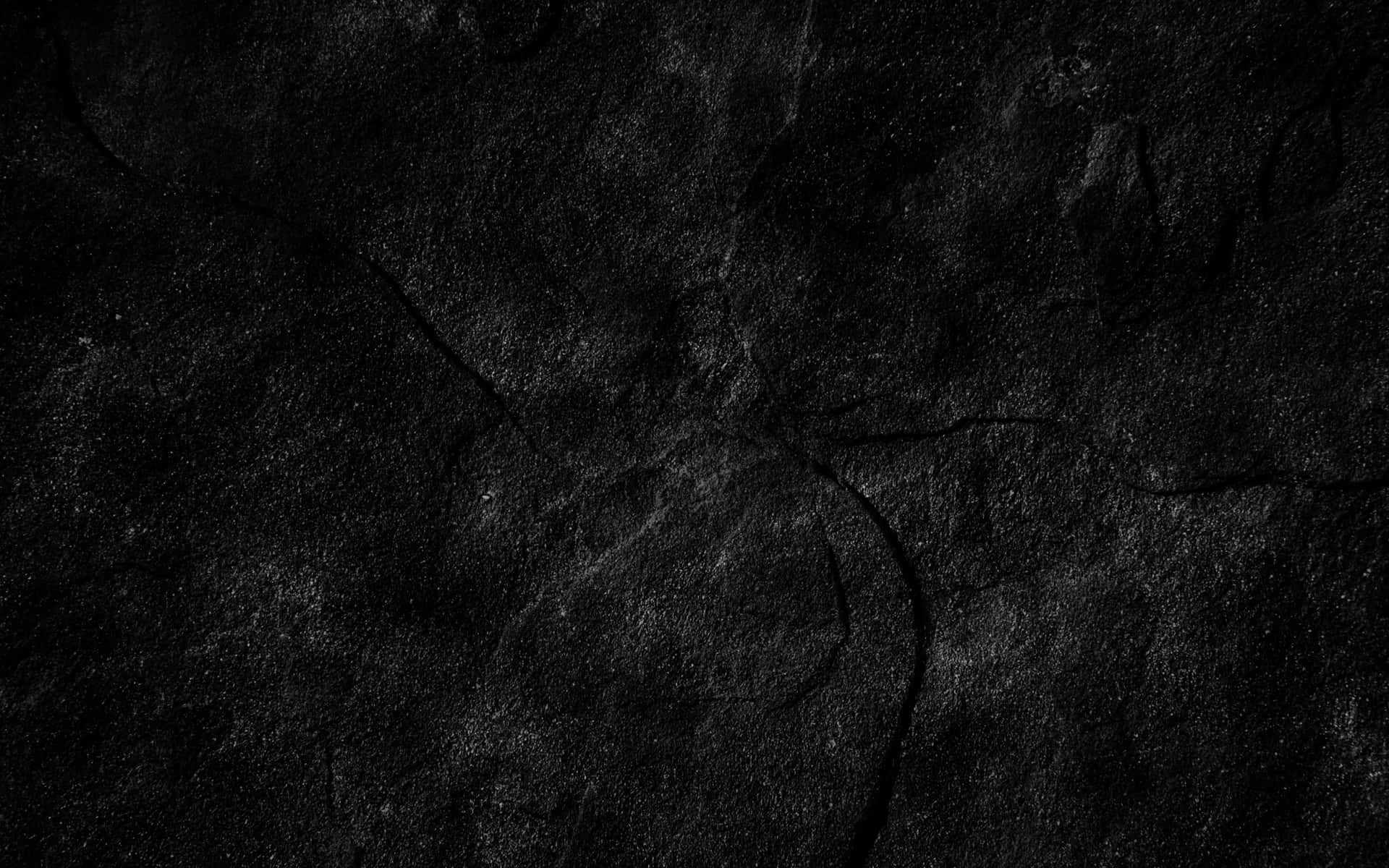 Caption: Mysterious Dark Rock Formation Wallpaper