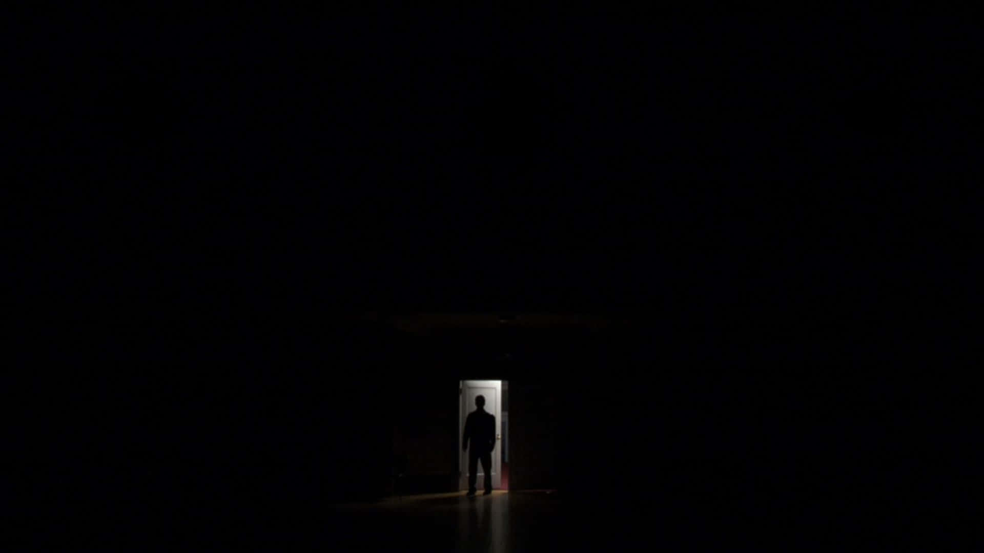 Mysterious Dark Room with a Single Light Source Wallpaper