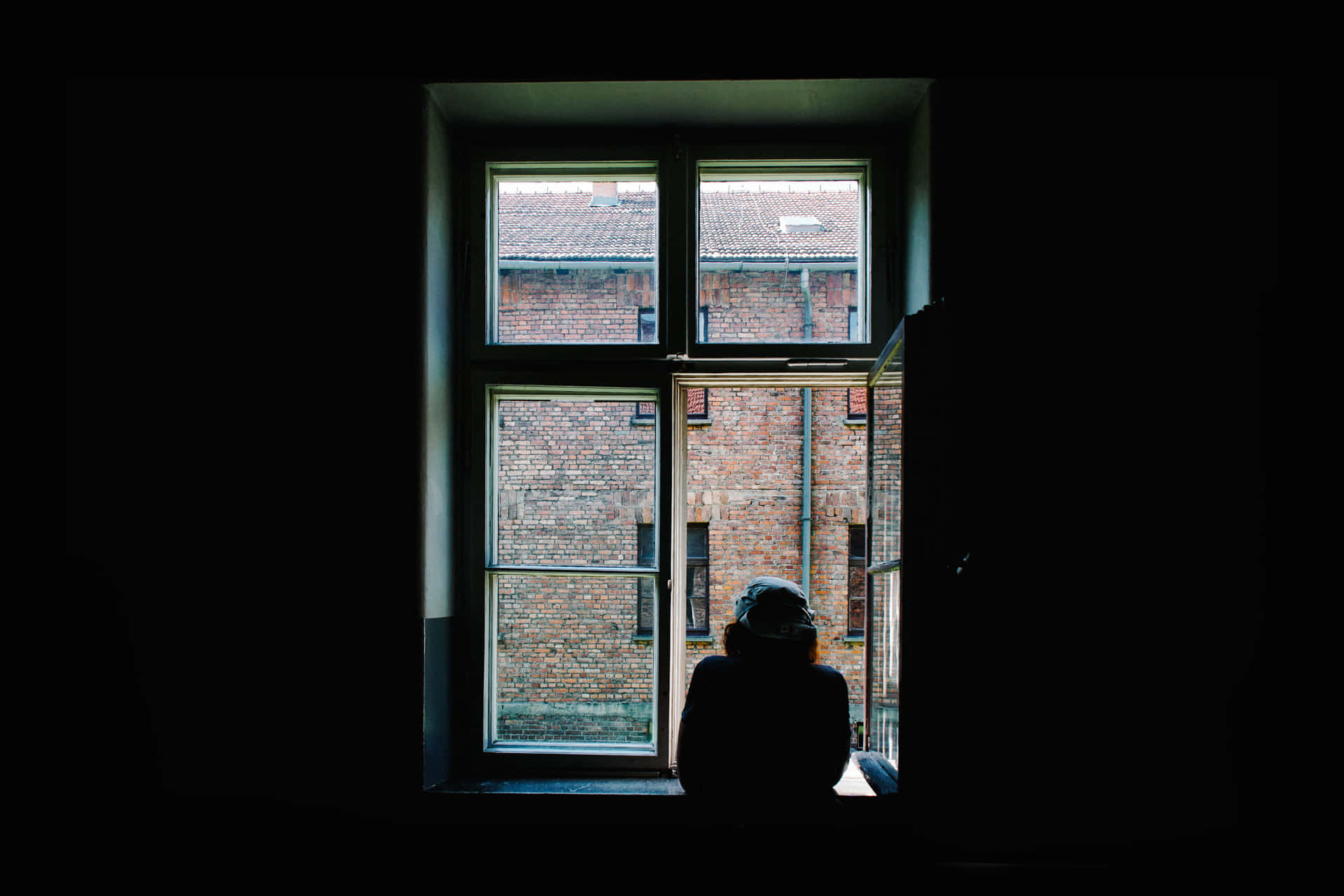 A Person Sitting In A Window