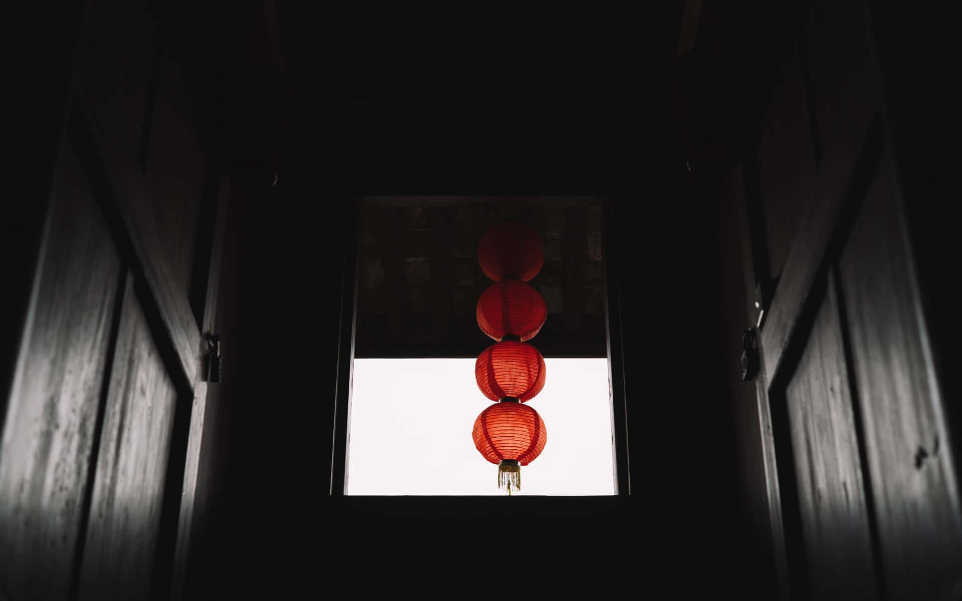Red Lanterns Hanging From A Window