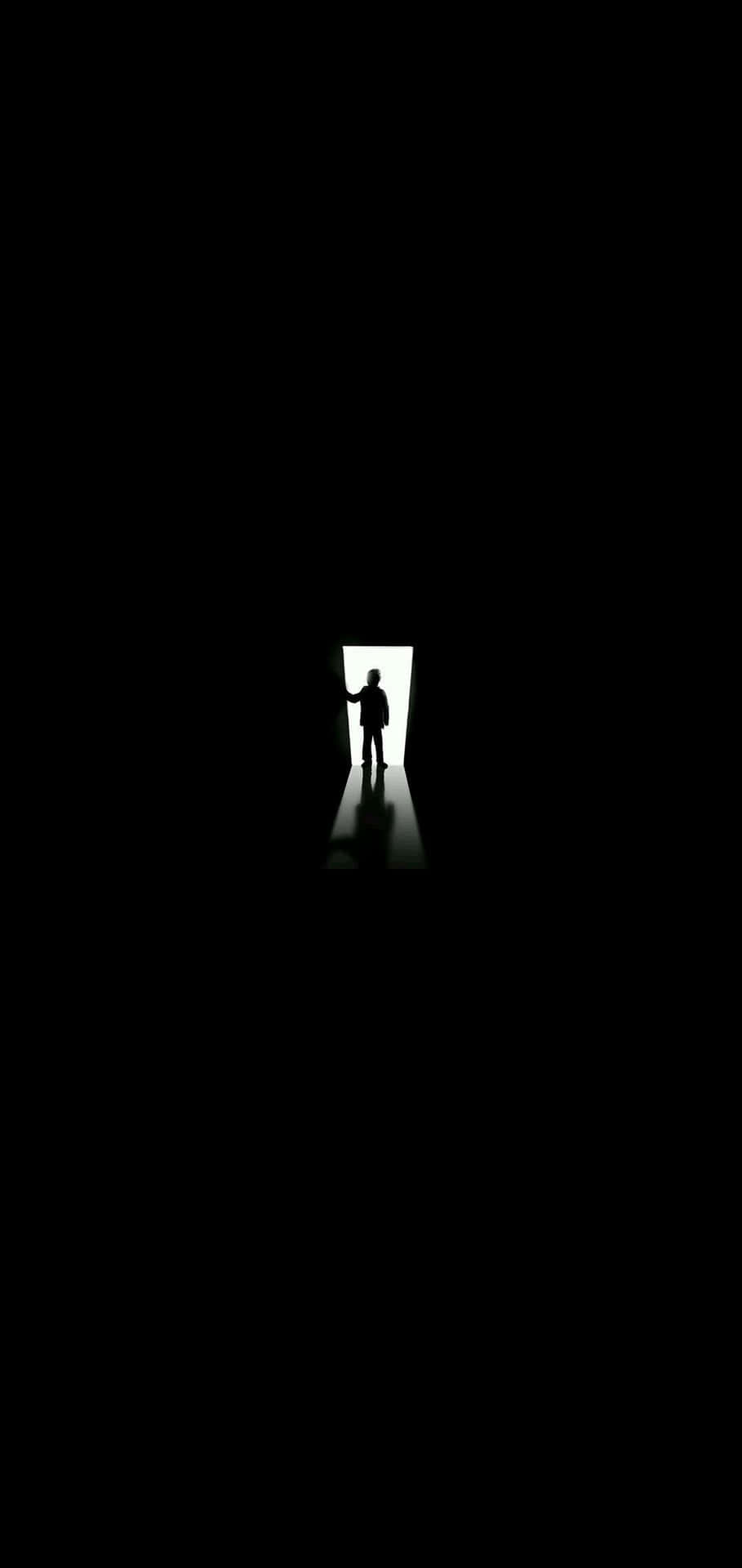 A Silhouette Of A Person In The Dark
