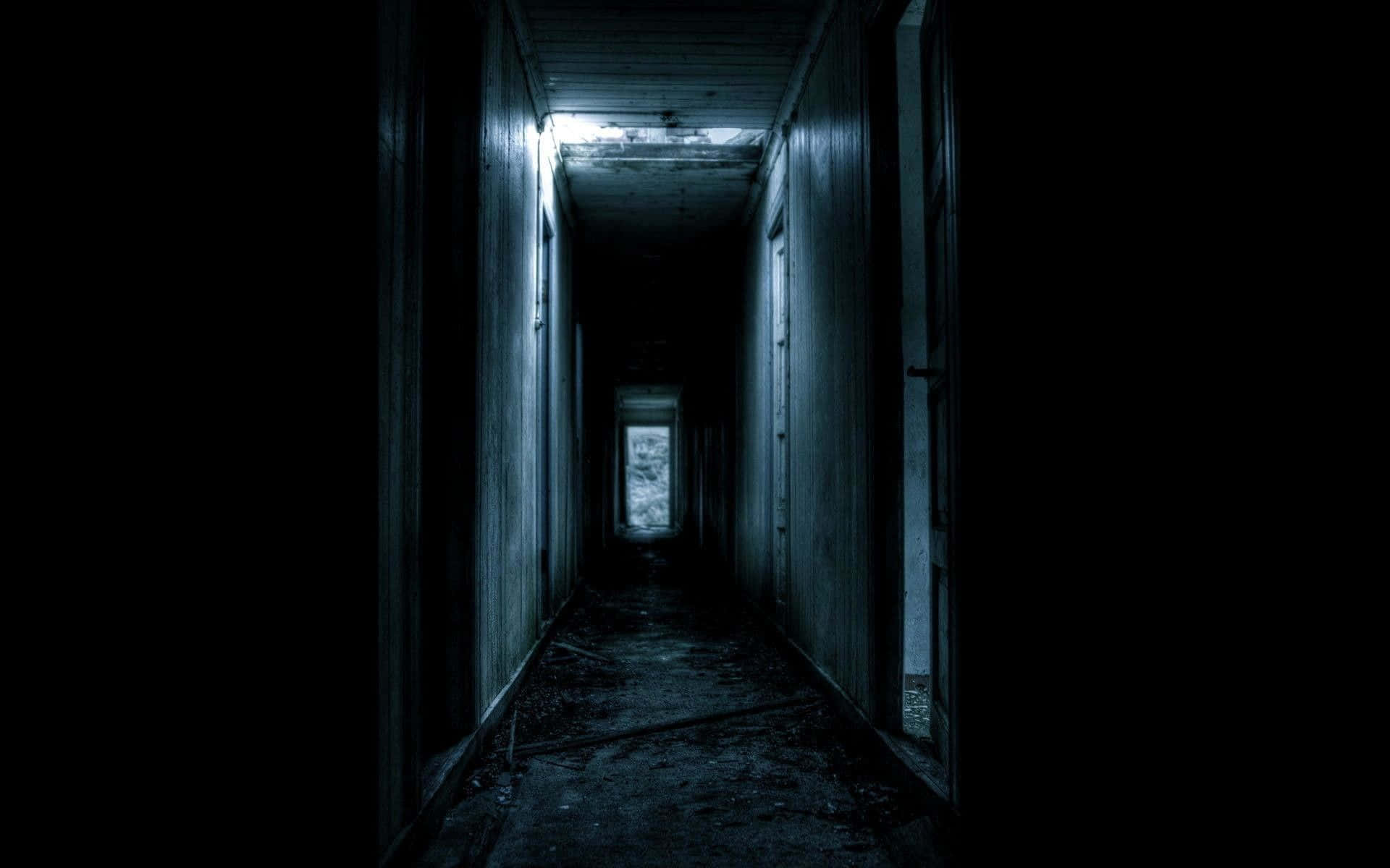 A Dark Hallway With A Light Shining Through It