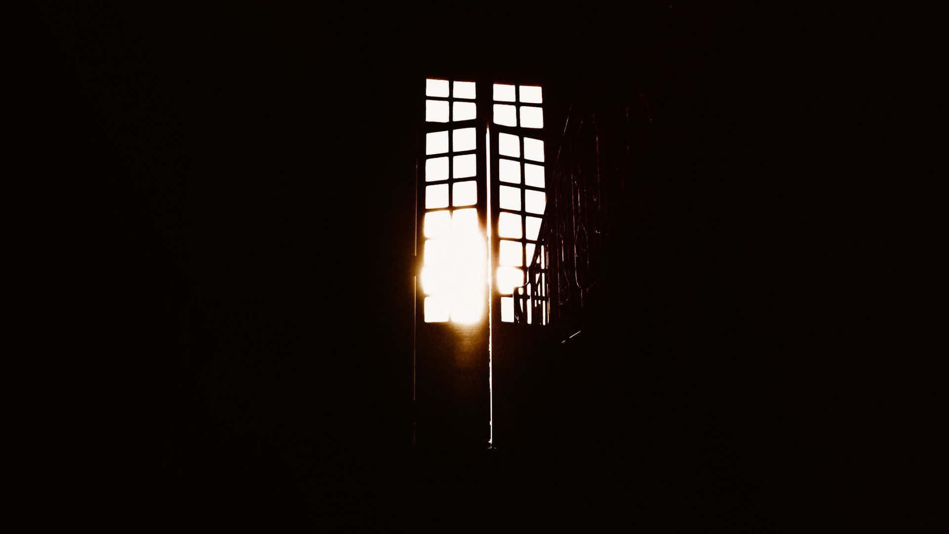 A Window With A Light Shining Through It