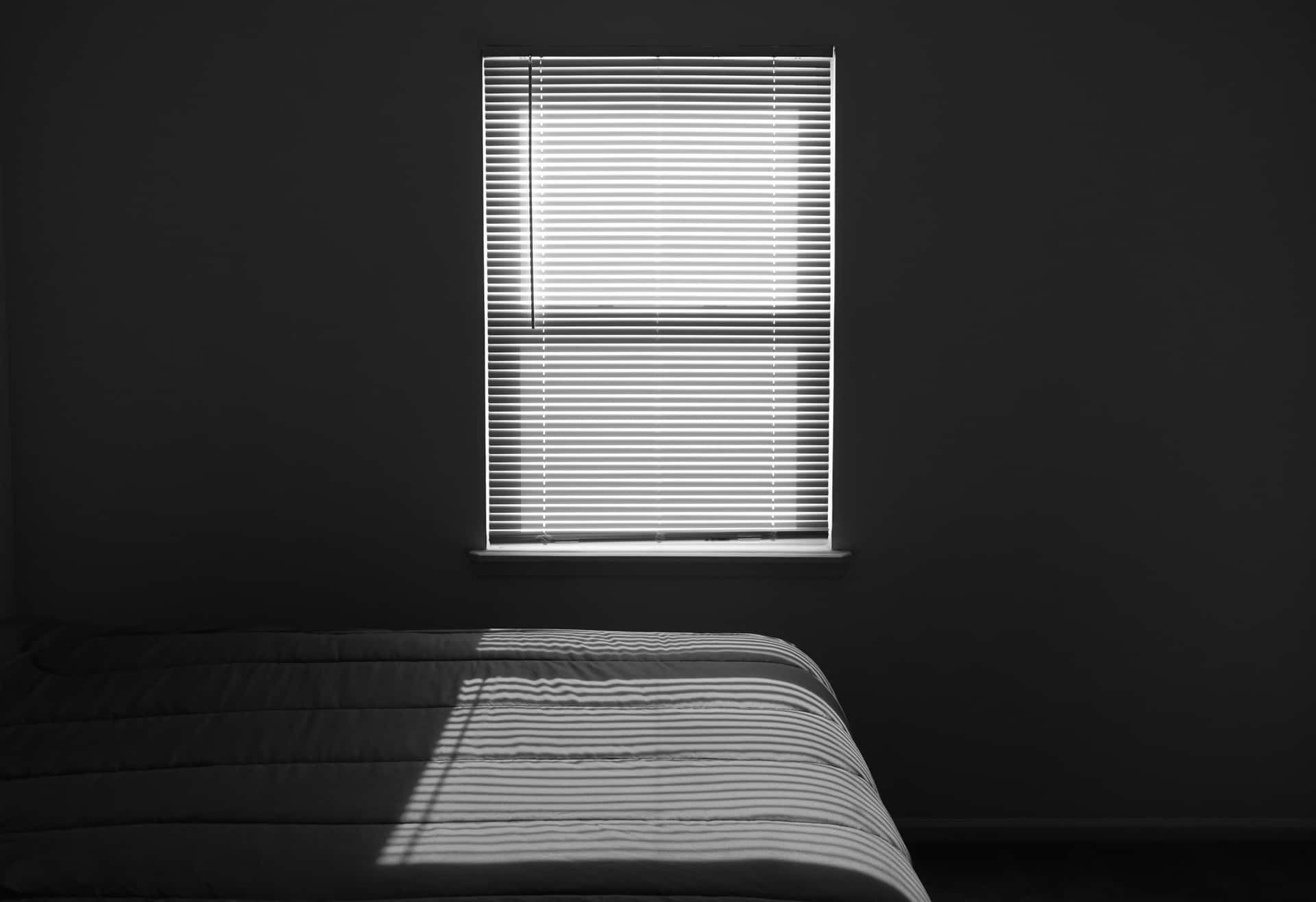 A Bed In A Room With A Window