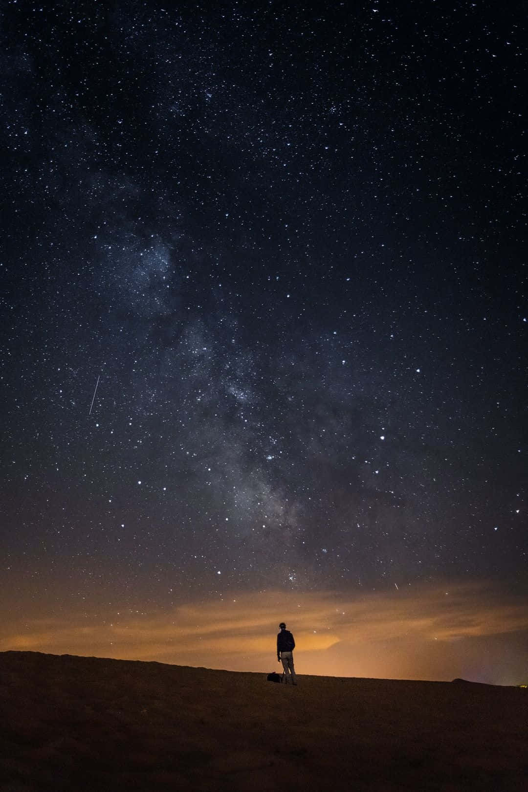 Alone Man In A Dark Starry Night Wallpaper