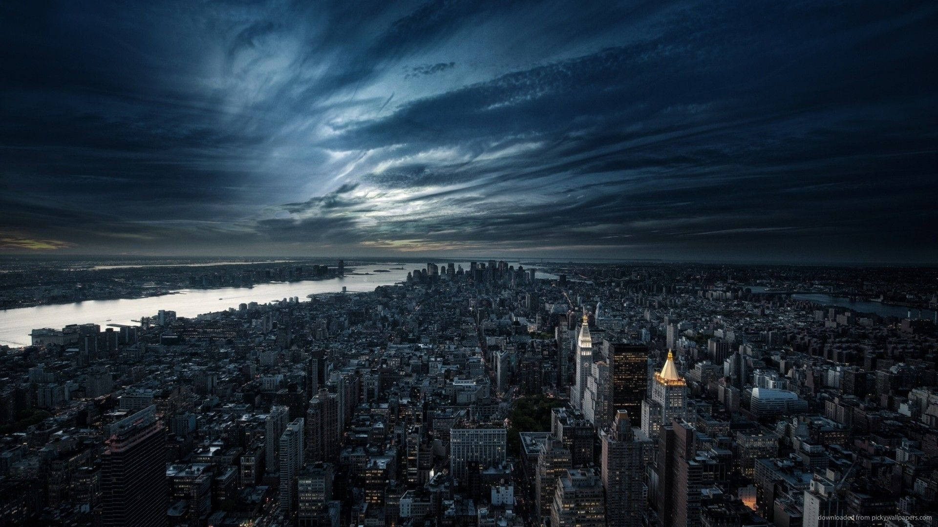Cityscape Illuminated by Dark Clouds Wallpaper