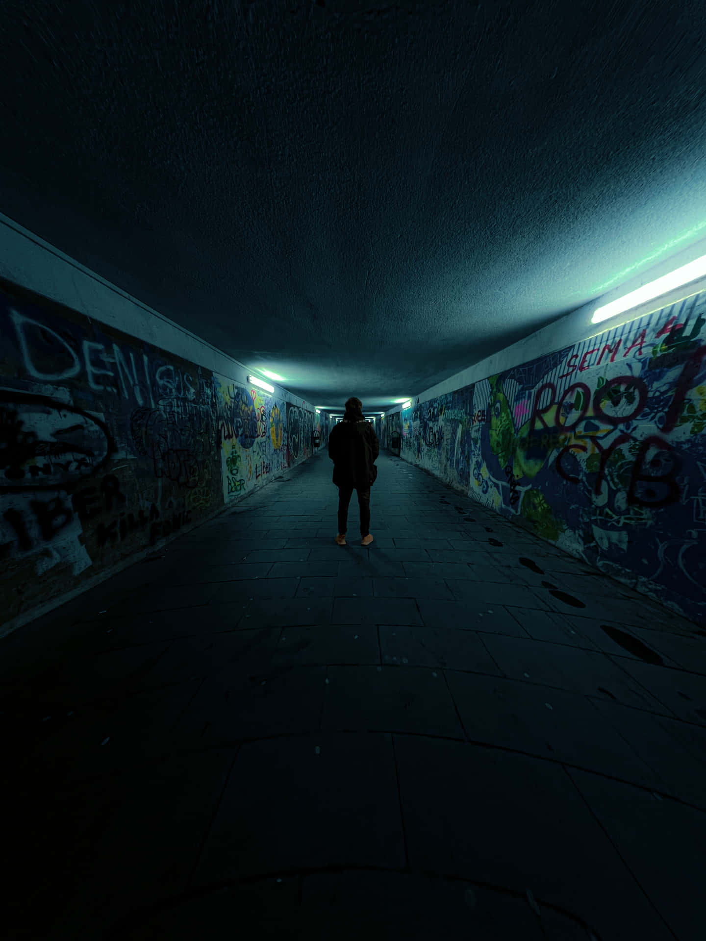 Caption: A Mysterious Stairway in a Dark Underground Tunnel Wallpaper