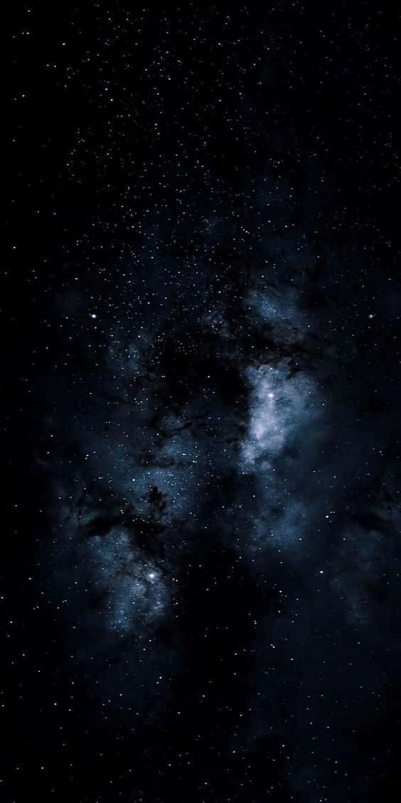 a dark space with stars and clouds Wallpaper