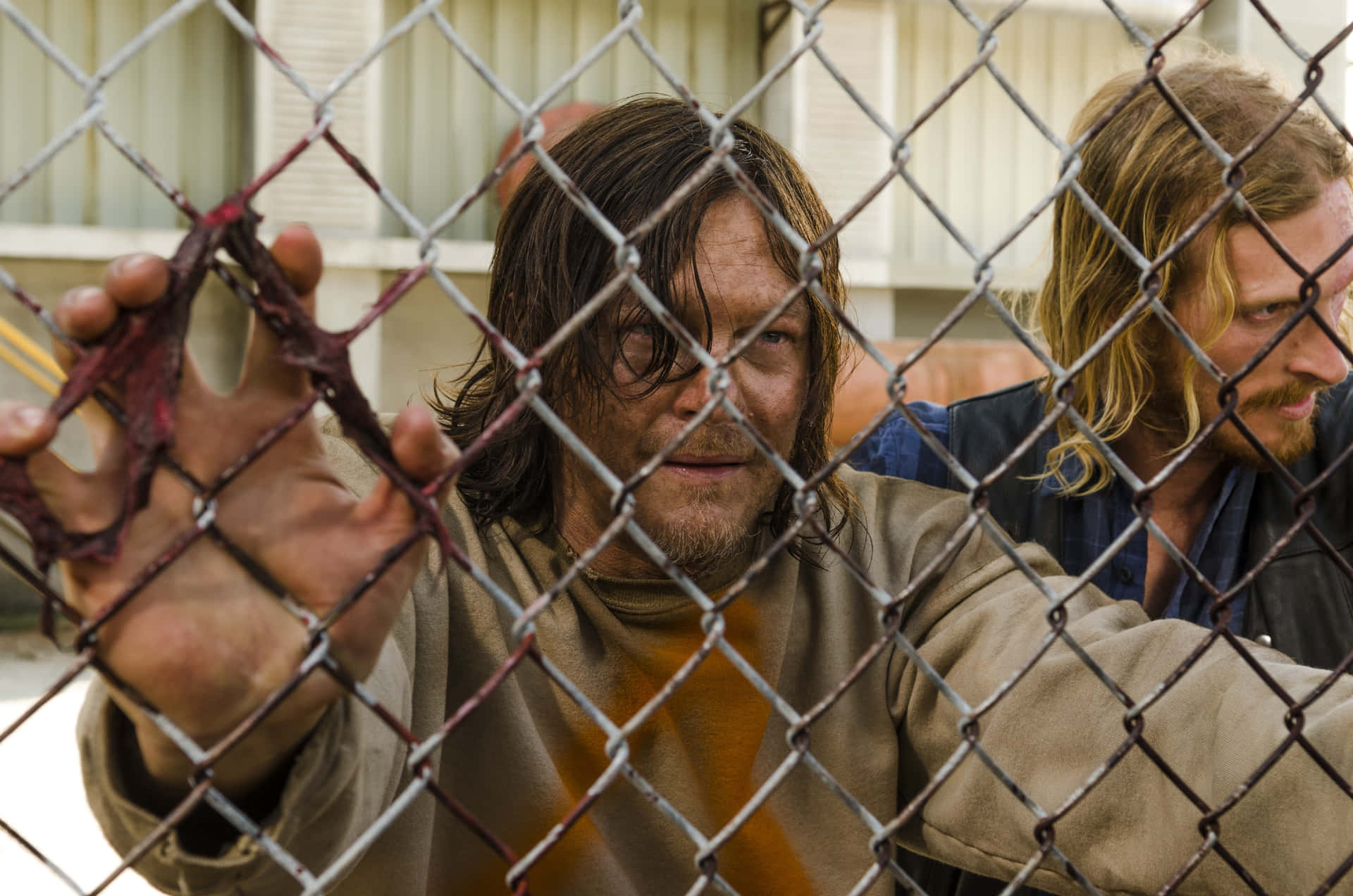 Daryl Dixon Behind Chain Link Fence Wallpaper