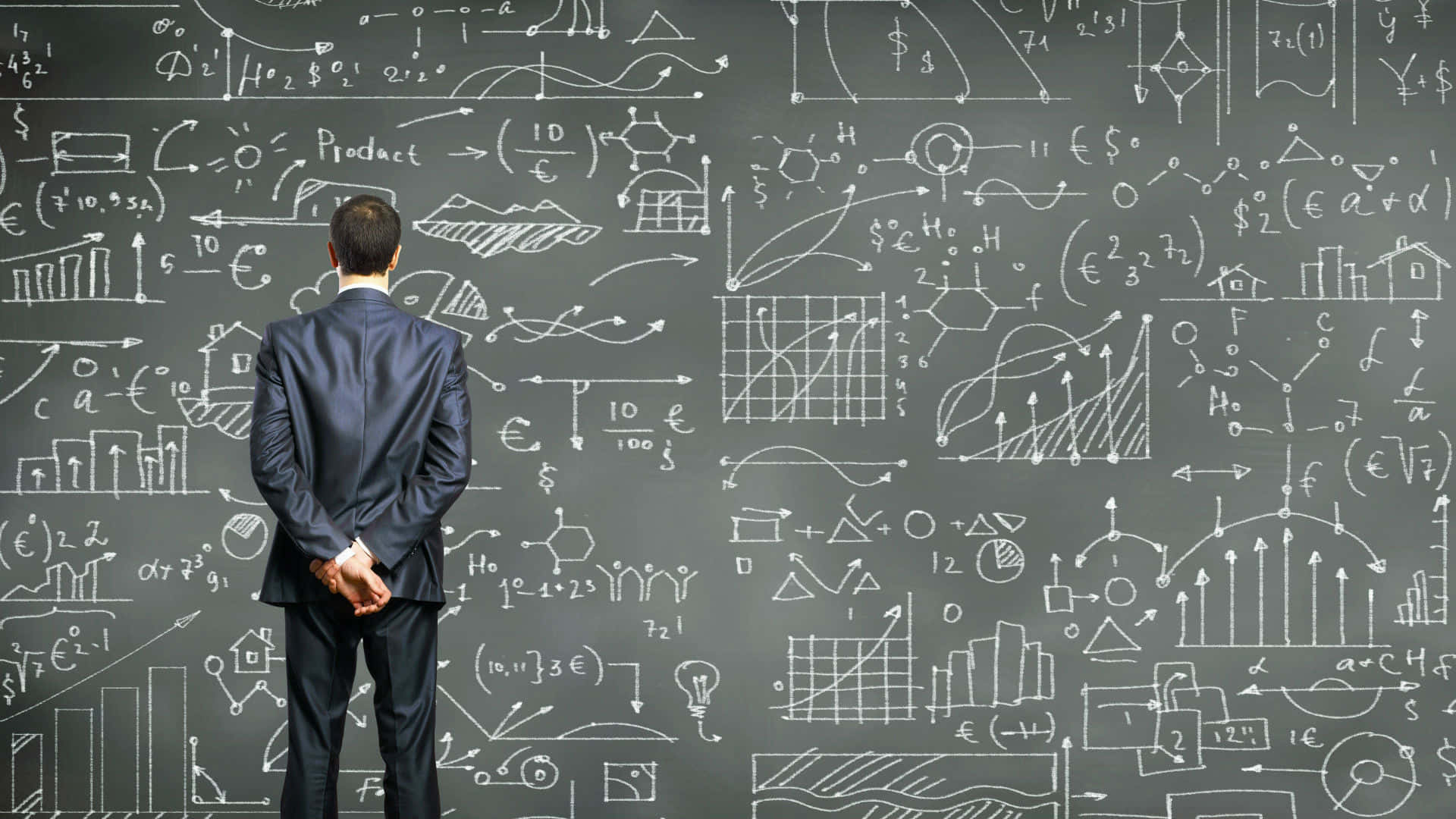 A Businessman Standing In Front Of A Blackboard With Mathematical Diagrams