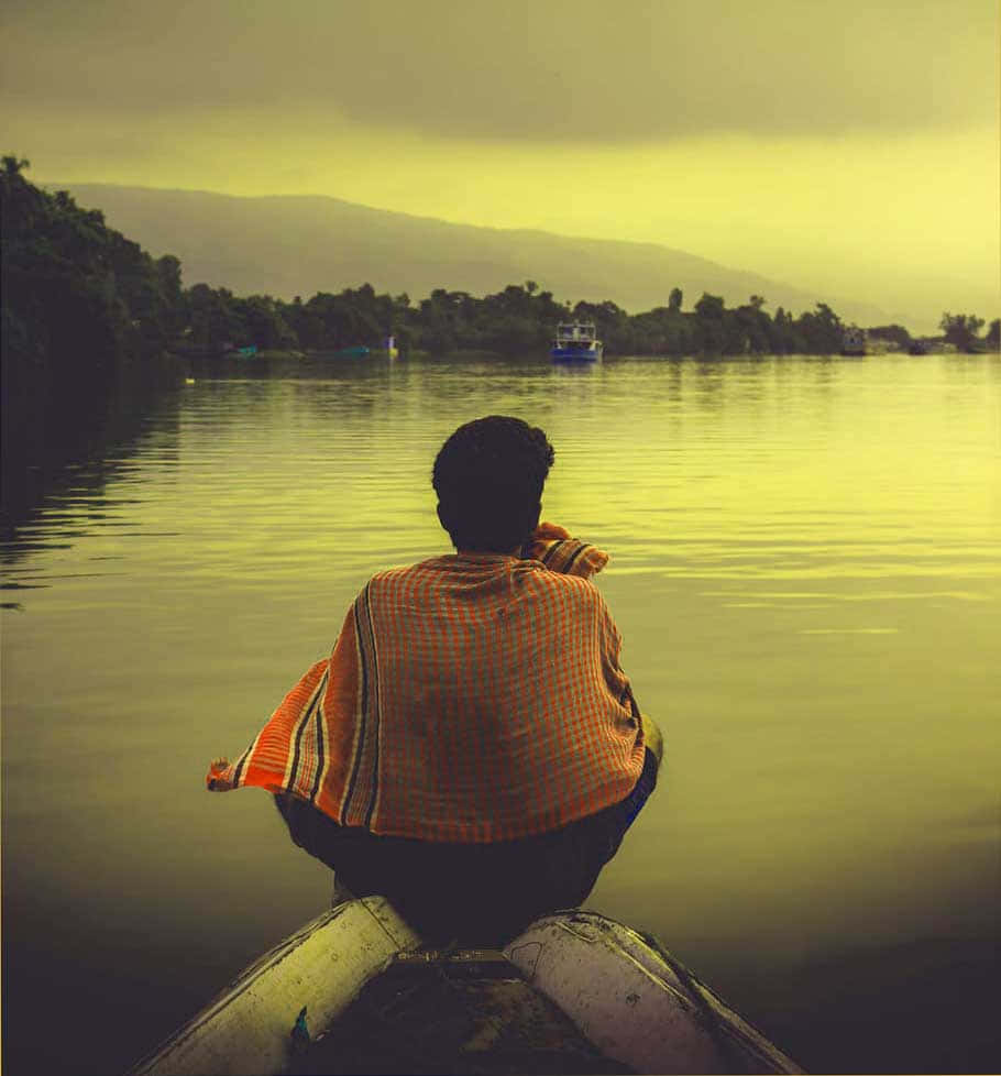 A Man Sitting On A Boat