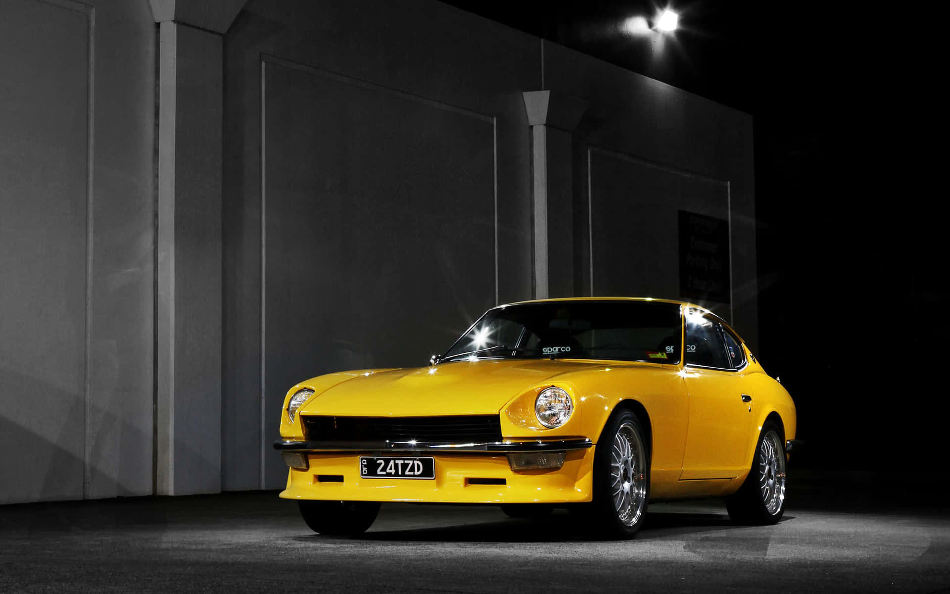 Caption: Stunning Datsun Classic Car in Action Wallpaper