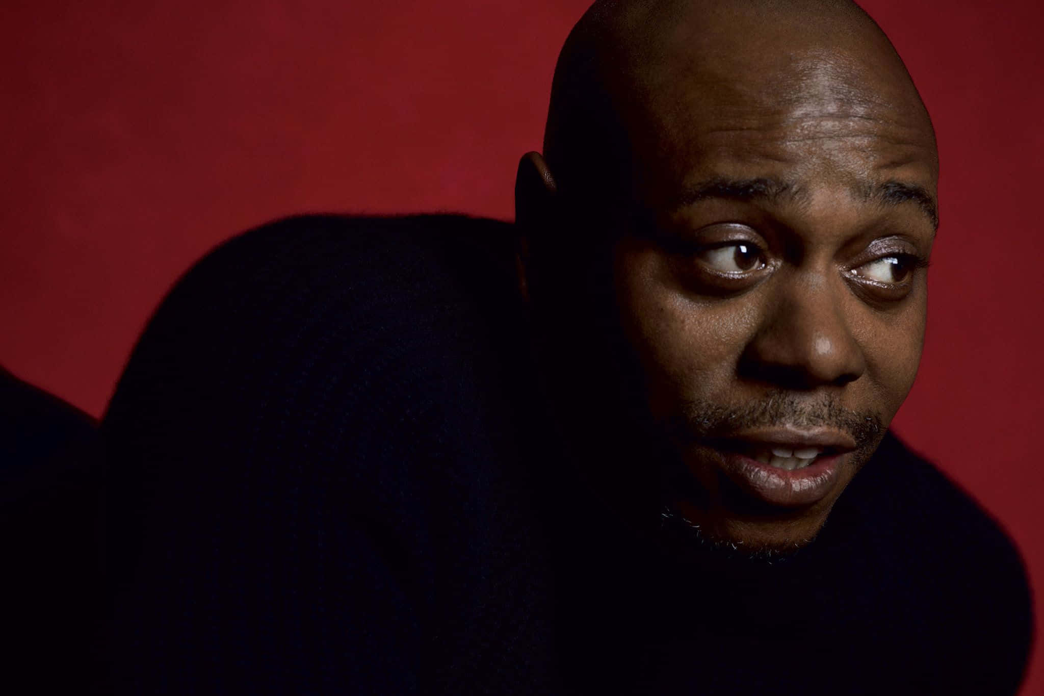 Dave Chappelle Poserer Selvsikkert På Scene. Bakgrunnsbildet