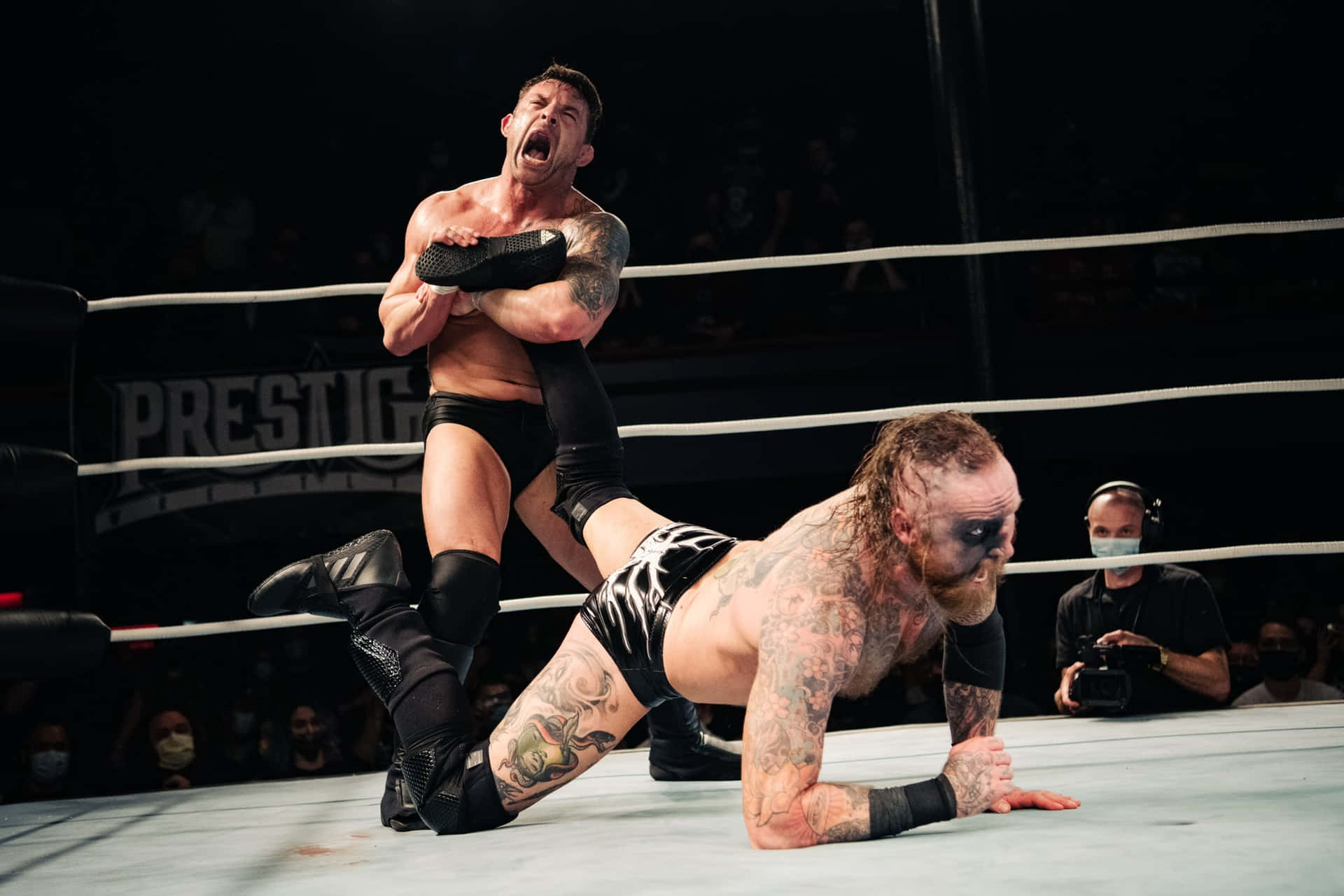 Intense Wrestling Match Between Davey Richards and Malakai Black Wallpaper
