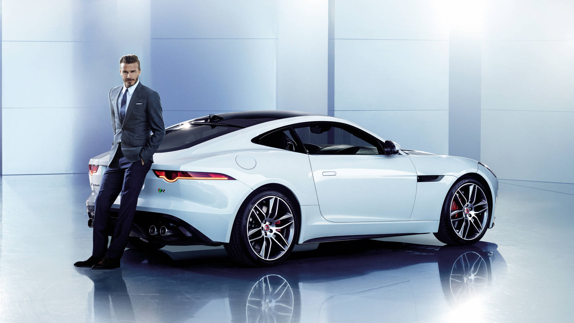 David Beckham poses with a sleek Jaguar Wallpaper