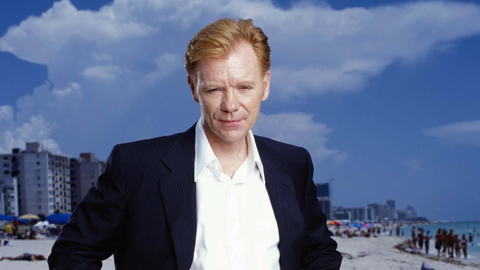 David Caruso striking a pose in a suit against a city backdrop Wallpaper