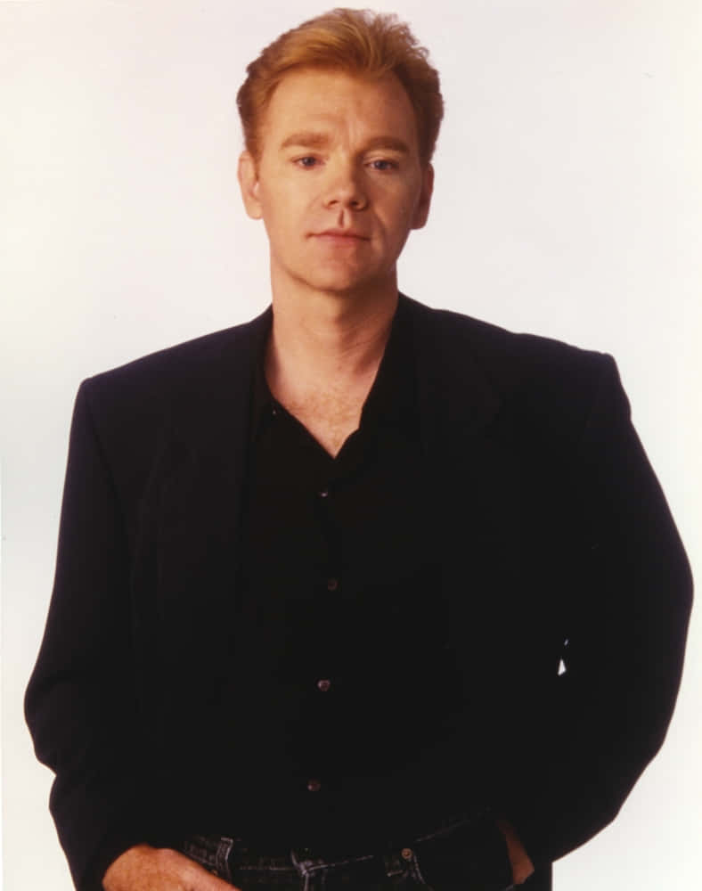 David Caruso striking a pose in a stylish suit. Wallpaper