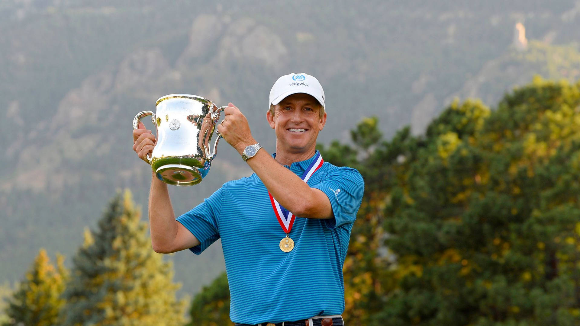 David Toms celebrating his victory with a medal and trophy. Wallpaper