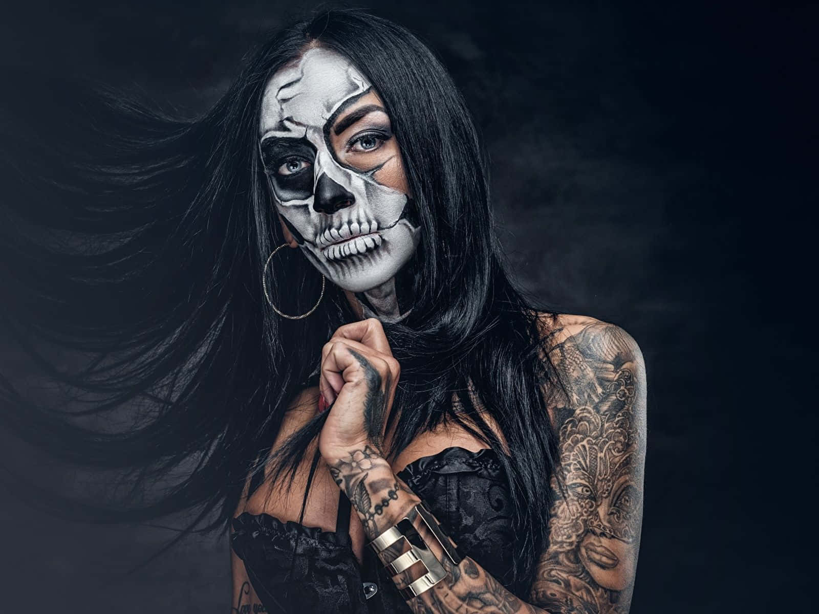 A Woman With Skeleton Makeup And Tattoos
