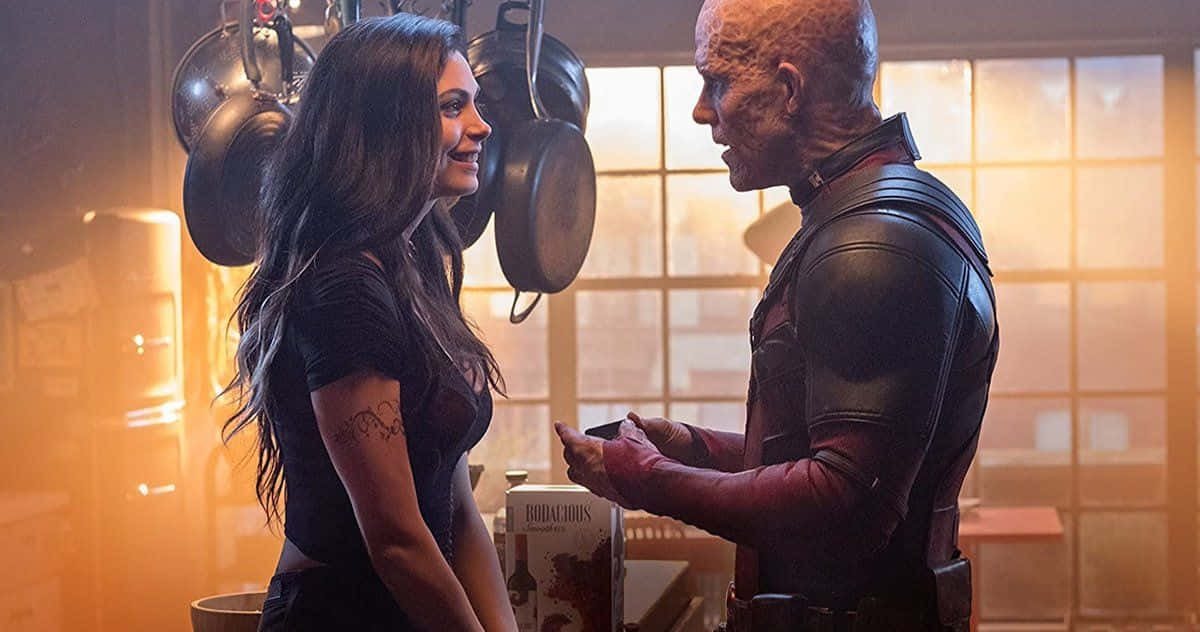 Deadpool and Vanessa sharing a romantic moment together Wallpaper