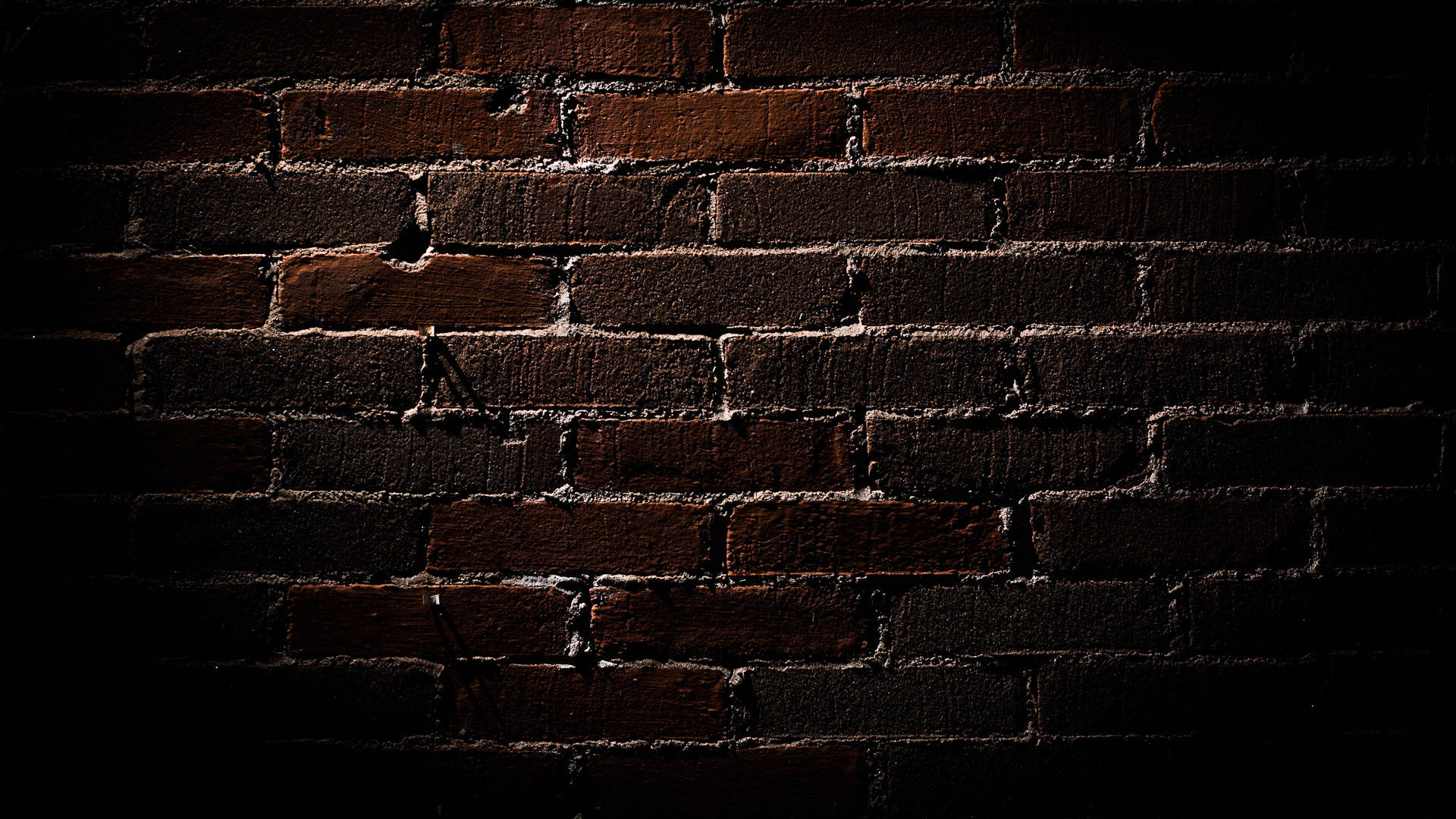 Deep Brown Brick Texture In Dim Light Wallpaper