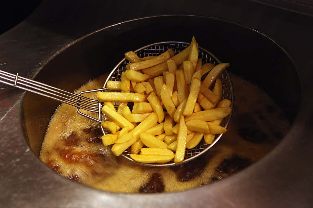 A Metal Basket With Fries In It
