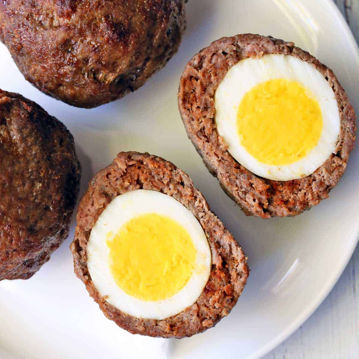 Delectable Traditional British Scotch Eggs Dish On Plate Wallpaper