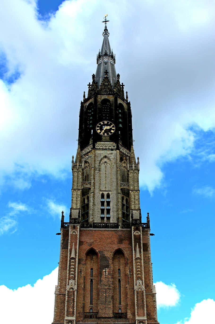 Delft Church Tower Against Cloudy Sky Wallpaper