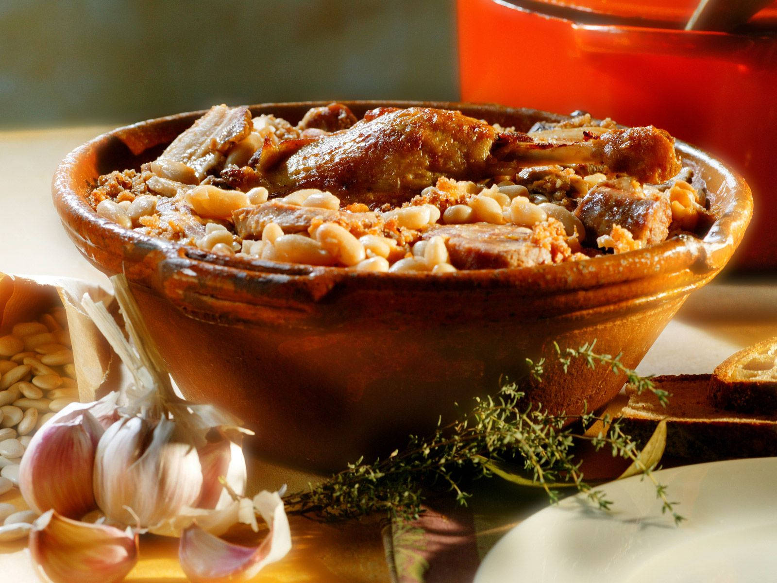 Delicious Cassoulet French Dish Surrounded By Herbs And Spices Wallpaper