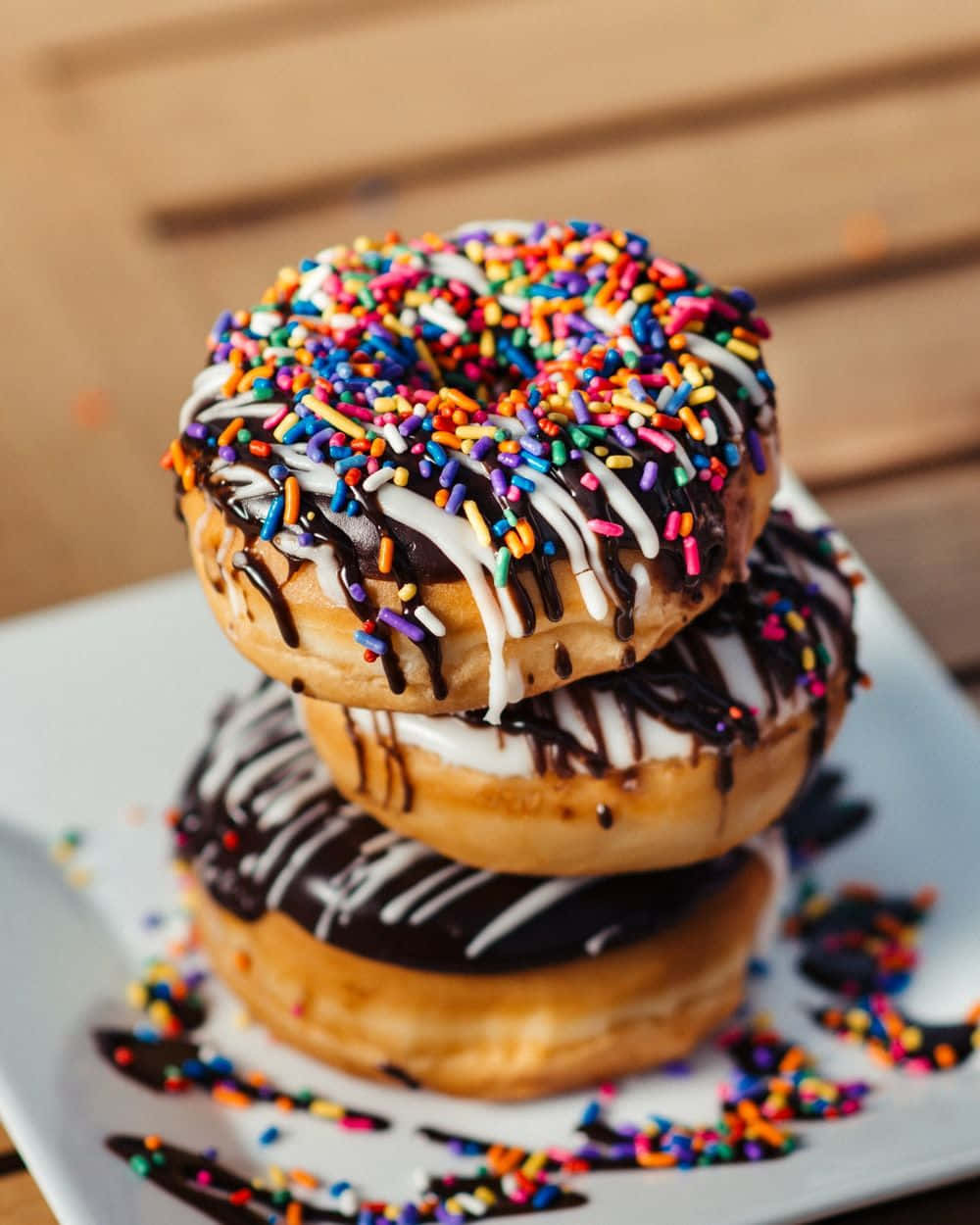 A Stack Of Donuts With Sprinkles On Top