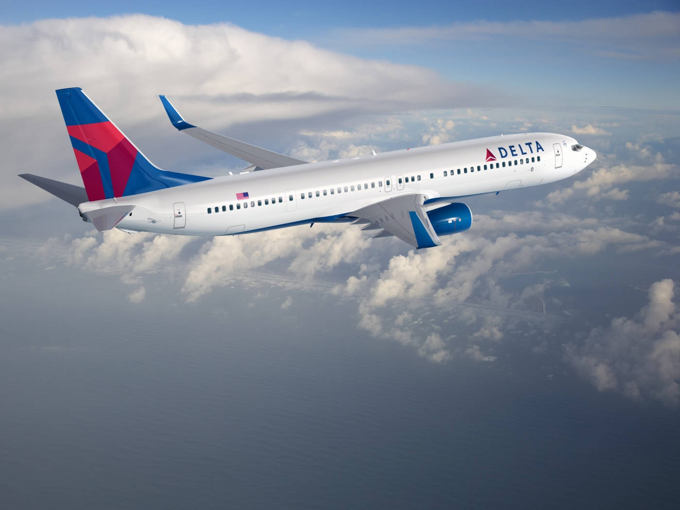 Aviónde Delta Airlines Volando Sobre Las Nubes Fondo de pantalla